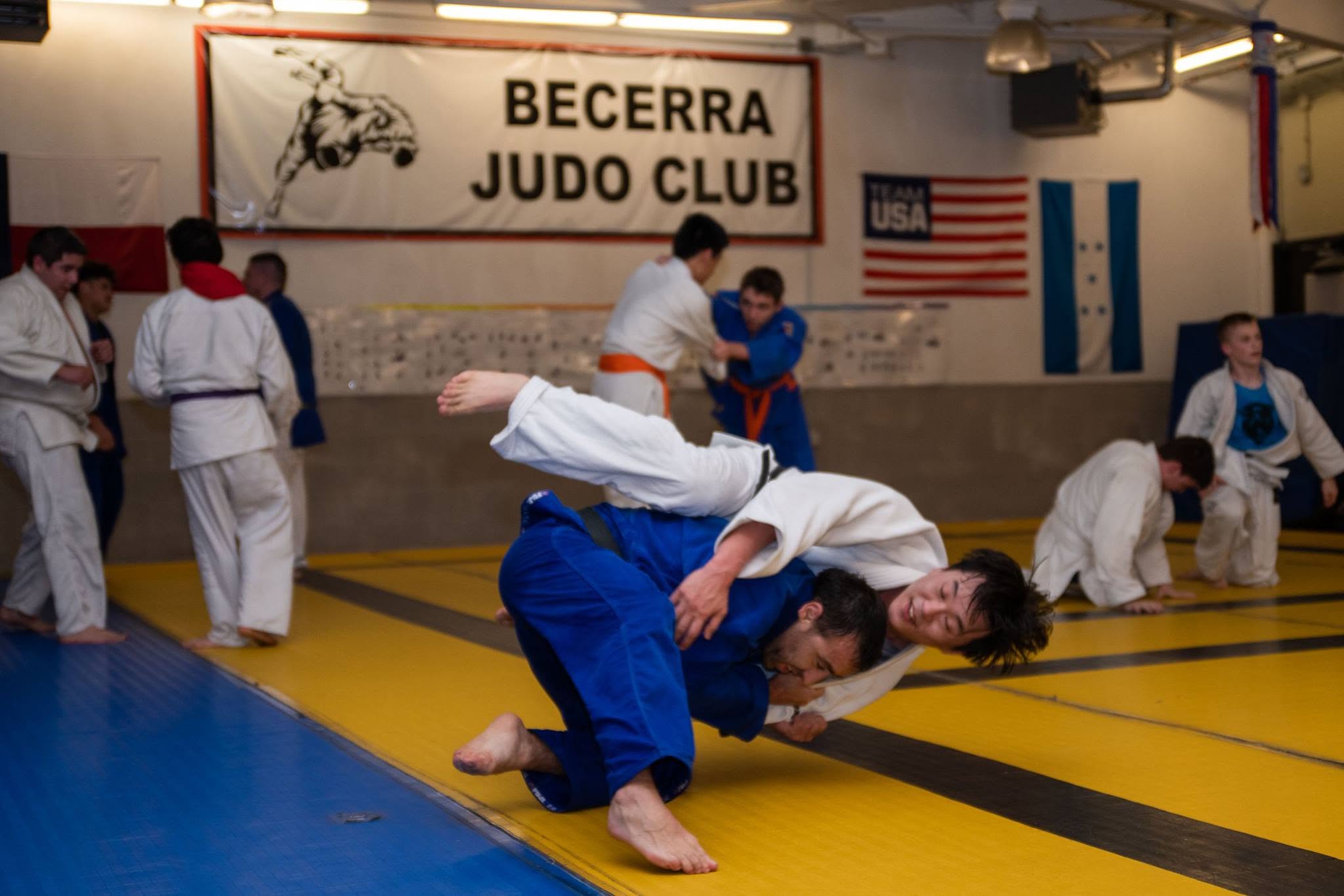 Two Becerra Judo athletes practicing a throw on the mat
