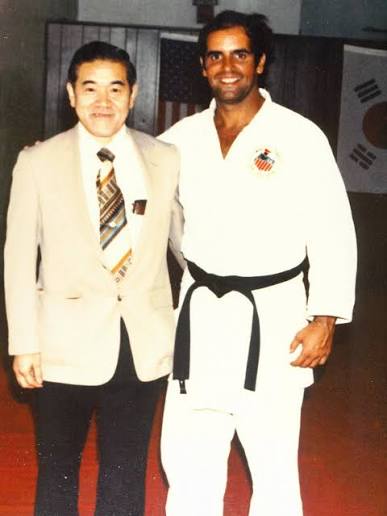 Humberto Bert Becerra in a judo uniform with a fellow martial artist