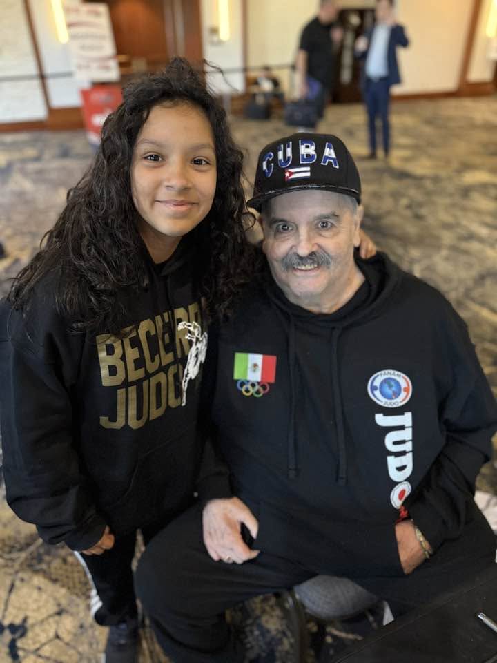 A young Becerra Judo athlete with a club mentor
